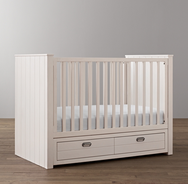 white crib with storage