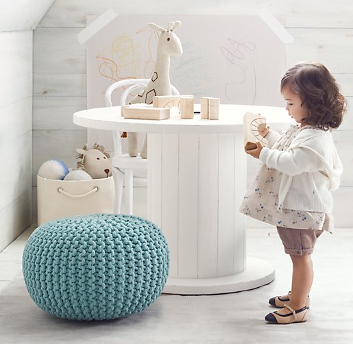 white wire spool used as a table in little girl room with blue puff
